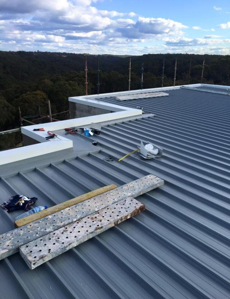 Roofer inspecting storm damage on a residential roof