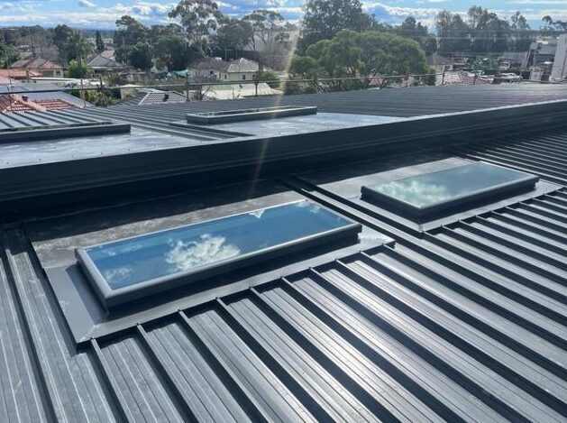 Roof repair work following storm damage around skylights