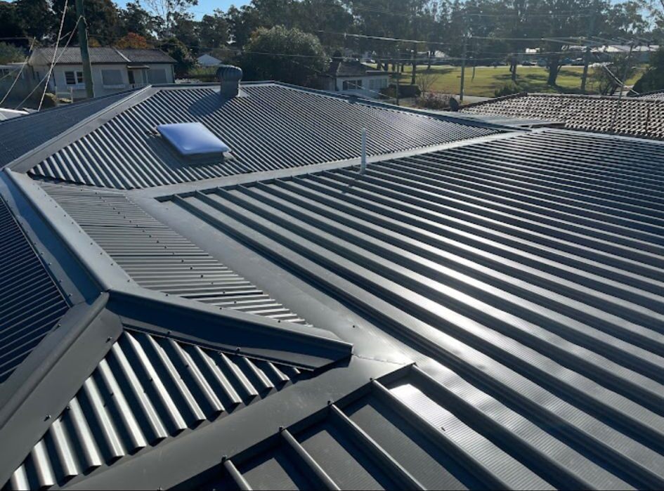 Repaired residential roof under a clear sky