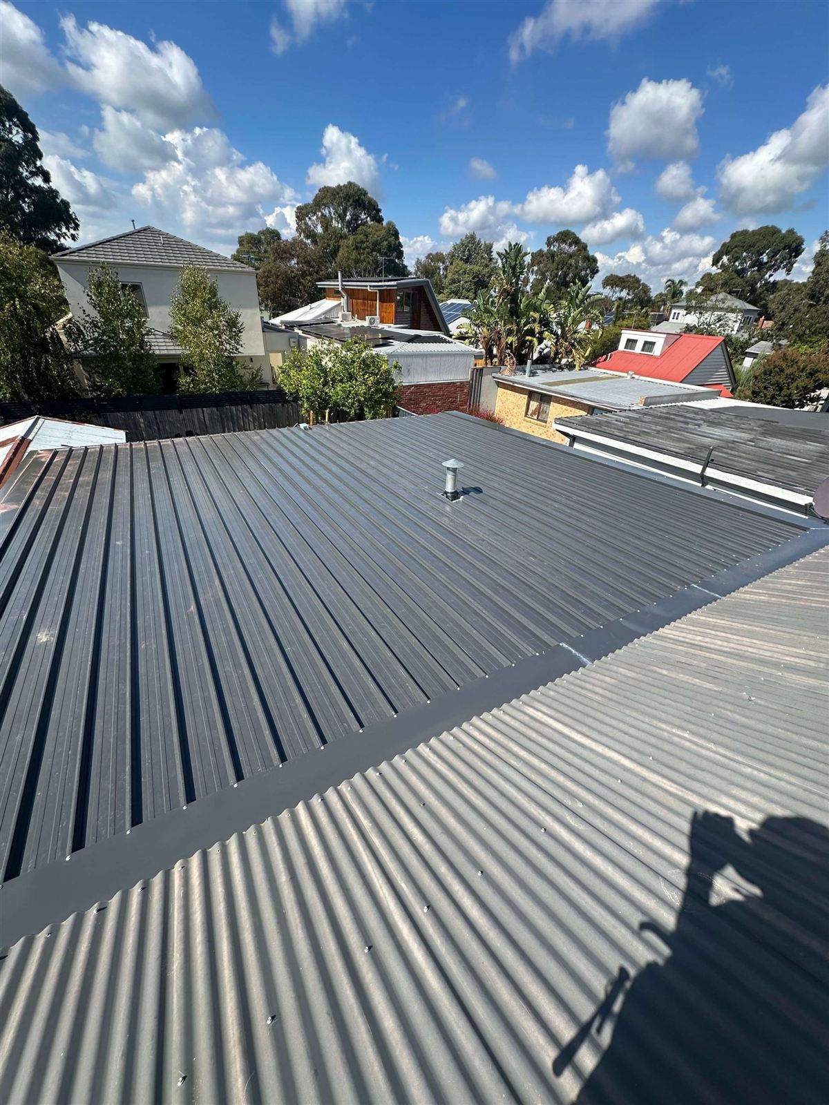 Suburban rooftops in Perth, tile and metal roofs